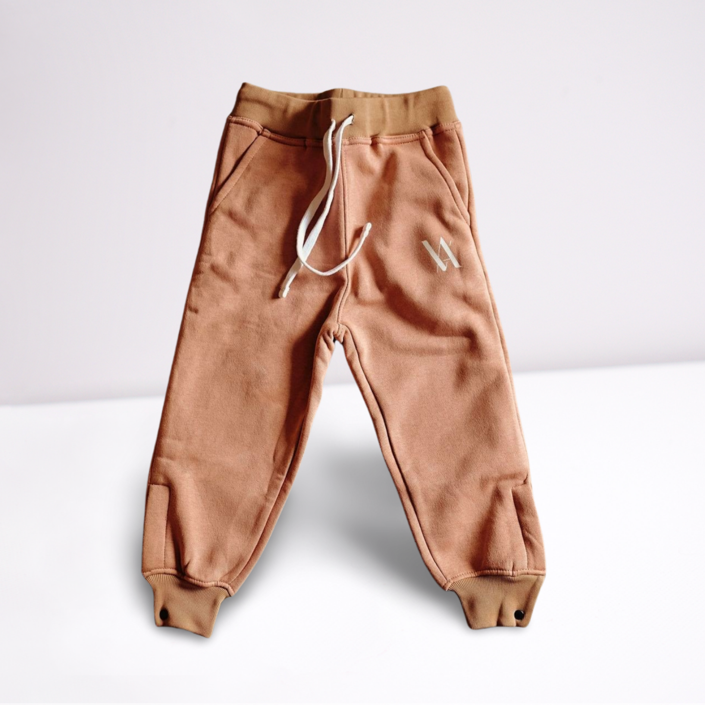 Pink sweatpants with white VA logo and white drawstrings.